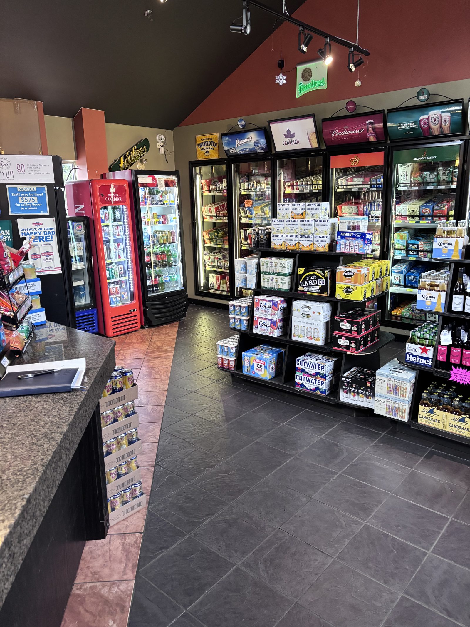 Inside Walnut Grove Liquor Store, checkout counter and coolers